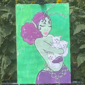May include: A painting of a green-skinned woman with purple hair and a long antenna. She is holding three white kittens with black eyes. The background is green with white stars.
