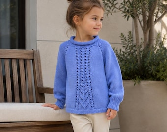 May include: A periwinkle blue long-sleeved knit jumper featuring a rolled collar and a vertical lace pattern down the centre front. The garment has raglan sleeves and ribbed cuffs, paired with plain light beige trousers.