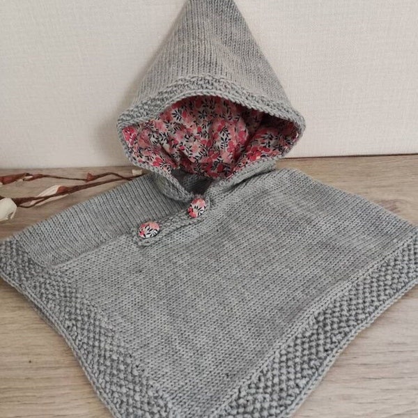 Hand-knitted baby hooded poncho in grey merino wool hood lined with liberty fabric