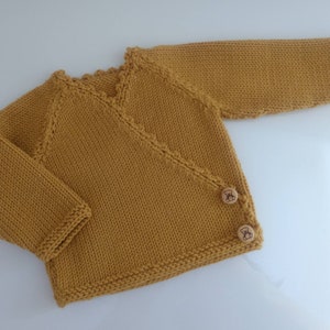 Baby wrap-around bra, hand-knitted layette in mustard merino wool and wooden buttons