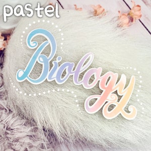May include: Pastel pink, blue and yellow watercolour sticker with the word "Biology" written in a cursive font.