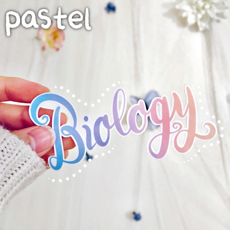 May include: A pastel pink and blue sticker with the word "Biology" written in a cursive font. The sticker has a white dotted border.