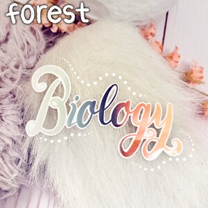 May include: A white fluffy background with a colourful sticker that says "Biology" in a cursive font.
