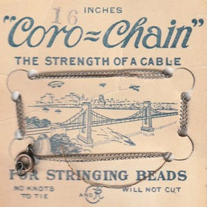 May include: Vintage Coro-Chain necklace chain, 16 inches long, displayed on a cardboard backing. The card features a blue illustration of a bridge and text that reads "The Strength of a Cable" and "For Stringing Beads."
