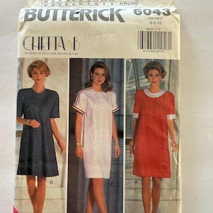 May include: A vintage Butterick sewing pattern envelope, featuring three dress designs. The envelope is labelled "6043" and includes the text "CHETTA B" and "YES! IT'S EASY! QUI! C'EST FACILE". The size range is 6-8-10.