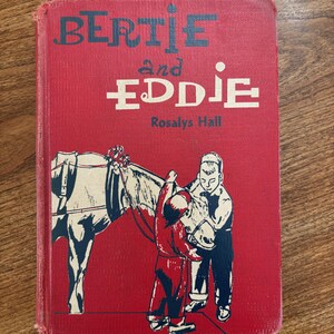 May include: A vintage children's book titled "BERTIE and EDDIE" by Rosalys Hall. The red cover features illustrations of two boys and a horse. The book's title is in large, bold letters.