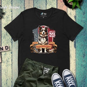 Miniature American Shepherd Cartoon Unisex T-Shirt – ‘Compact Love, Huge Heart’ Design with Faded American Flag Background