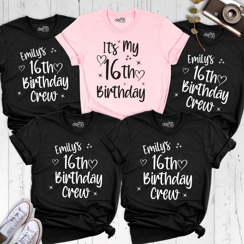 May include: A selection of black and pink t-shirts with white lettering. The black shirts display "Emily's 16th Birthday Crew", while the pink one reads "It's My 16th Birthday". The t-shirts are short-sleeved.