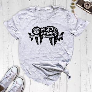 May include: Gray t-shirt with a black sloth graphic and the text "My spirit animal".