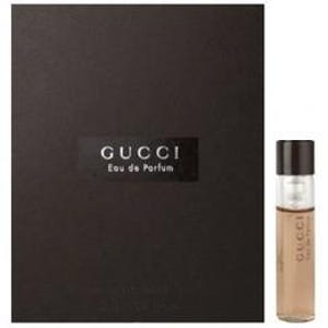 May include: A small brown bottle of Gucci Eau de Parfum with a black cap and a black box.