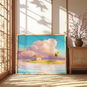 May include: A framed art print showing a tranquil landscape. A small house with an orange roof is on a green island, surrounded by water. Fluffy pink and white clouds fill the sky above a turquoise horizon. A single tree stands near the house.