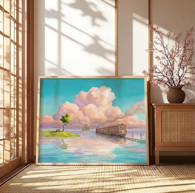 May include: A framed watercolor painting depicts a train traveling across water towards a small island with a tree. The sky is a mix of blue and pink, with fluffy clouds. The artwork is in a wooden frame.