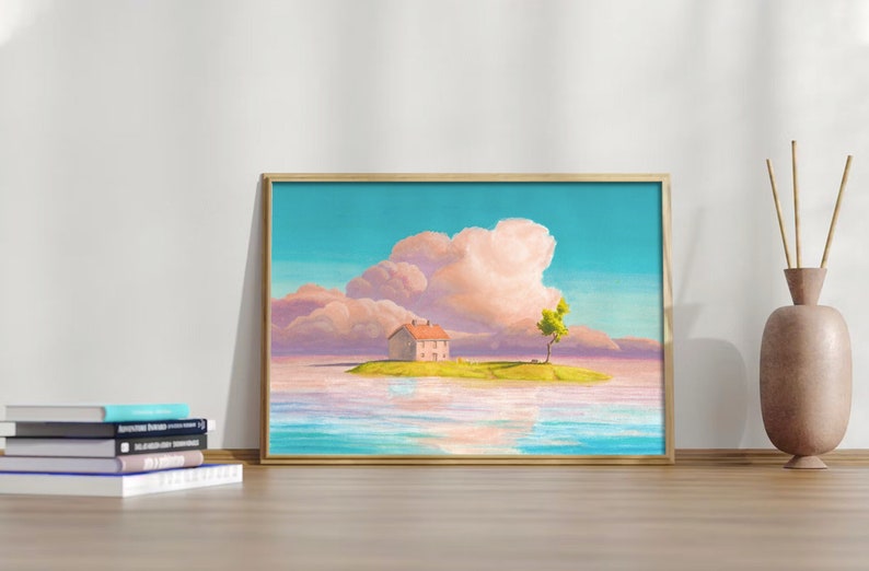 May include: A framed art print showing a tranquil island scene. A small house with a red roof is on a green island with a tree. The sky is a gradient of blue and pink, with fluffy clouds. The print is in a gold frame.