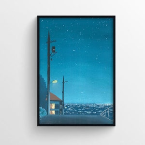 May include: A framed art print depicting a nighttime cityscape. The artwork features a road leading towards a distant city, with a house and streetlights. The sky is a deep blue, dotted with stars, creating a serene and atmospheric scene.