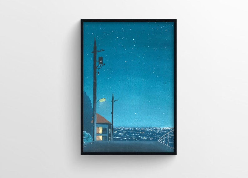 May include: A framed art print depicting a nighttime cityscape. The artwork features a road leading towards a distant city, with a house and streetlights. The sky is a deep blue, dotted with stars, creating a serene and atmospheric scene.