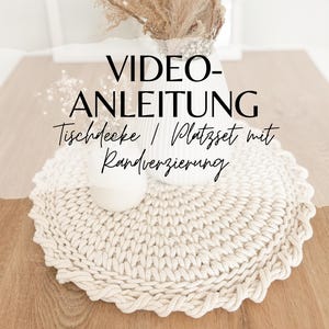 May include: A video tutorial for crocheting a table runner or placemat with a decorative edge. The image shows a close-up of a crocheted placemat with a white, textured, rope-like yarn.