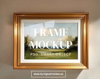 May include: A gold rectangular frame with a landscape painting inside, hanging on a neutral wall. The frame has a glossy finish and a thick border. Text on the painting reads "FRAME MOCKUP PSD SMART OBJECT". The text "Made By DigitalPrintMarvel" is also visible.