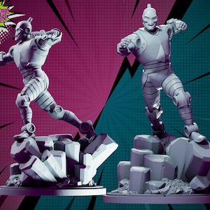 May include: Two gray, metallic robot figures with a skull-like head and a pointed helmet. The figures are posed in a dynamic action stance, standing on a gray, rocky base. The figures are against a pink and teal background with a white speech bubble that says "HARDCORE MINIATURES".