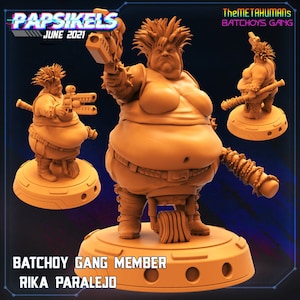 May include: A 3D printed miniature figurine of a female character with a large build, wearing a studded leather outfit and holding a weapon. The figurine is painted in a light orange color and is standing on a circular base. The text "BATCHOY GANG MEMBER RIKA PARALEJO" is printed on the base.