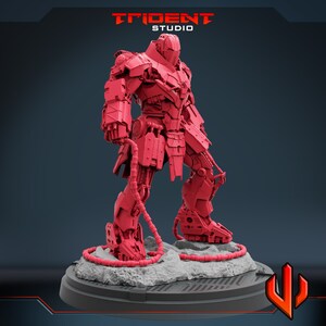 May include: A red, detailed, articulated robot figure standing on a gray base with a black grid pattern. The robot has a large head with a helmet and a body with many mechanical parts. The robot is holding a long, thin cable in its right hand.