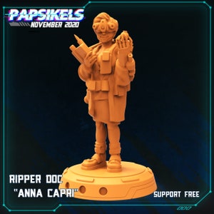 May include: Orange 3D printed miniature of a female character with a futuristic look, holding a weapon and a device. The character is wearing a long coat and goggles. The base of the miniature is round and has the text "RIPPER DOC "ANNA CAPRI" SUPPORT FREE" printed on it.
