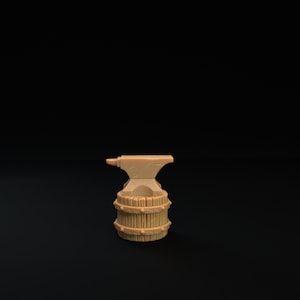 May include: A miniature metal anvil sits atop a wooden barrel, both painted in a light brown color. The anvil has a rounded top and a small horn on one side. The barrel has a series of hoops around it.