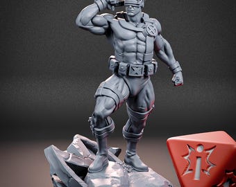 May include: A gray resin miniature figure of a muscular character wearing a visor, tactical belt with an X emblem, and boots, standing on a rocky base. Next to the figure is a red die with a white starburst symbol. Text reads NOH MINIATURES.