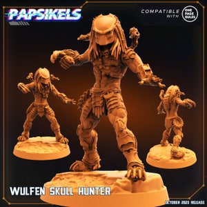 May include: A brown plastic miniature figure of a Predator, a fictional alien hunter, with a skull on its chest and a spear in its hand. The figure is standing on a brown base. The figure is labeled "Wulfen Skull Hunter" and is compatible with "One Page Rules".