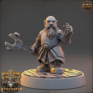 May include: A gray, detailed miniature figurine of a dwarf with a beard, wearing armor and holding a wrench. The dwarf is standing on a circular base with intricate designs.