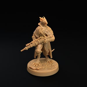 May include: A brown, detailed miniature figurine of a humanoid lizard-like creature wearing a long coat and holding a rifle. The figurine is standing on a round base with a textured surface.