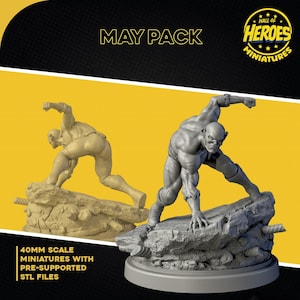 May include: Two 40mm scale miniatures of a muscular humanoid figure in a dynamic pose, one in beige and the other in gray, atop a rocky base. The text "MAY PACK" and "HALL OF HEROES MINIATURES" are visible. The miniatures are pre-supported and include STL files.
