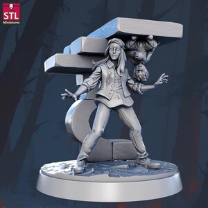 May include: A gray miniature figurine of a person in a button-up jacket and pants, with a distressed expression, supporting a stone structure. Another figure hangs upside down from the structure. The base is round.