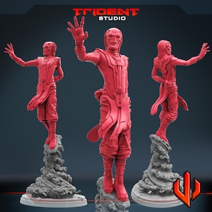 May include: Three red 3D printed figurines of a character with a long, flowing robe and a pointed hood. The character is posed in three different stances, with one hand raised in a gesture of power. The figurines are standing on a gray, textured base.
