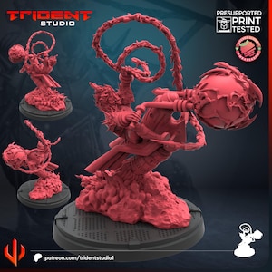 May include: A red 3D-printed miniature figure with intricate details, featuring a character holding a large orb and a spiraling element. The figure is on a circular base, with additional smaller versions of the figure. The Trident Studio logo is visible.