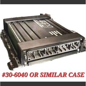 May include: Black electronic device with multiple connectors on the side. The device has a label that reads "#30-6040 OR SIMILAR CASE".