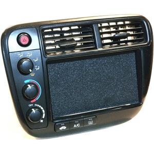 May include: Black plastic car dashboard panel with a digital display, air conditioning controls, and vents. The panel has buttons for "OFF", "A/C", and other functions.
