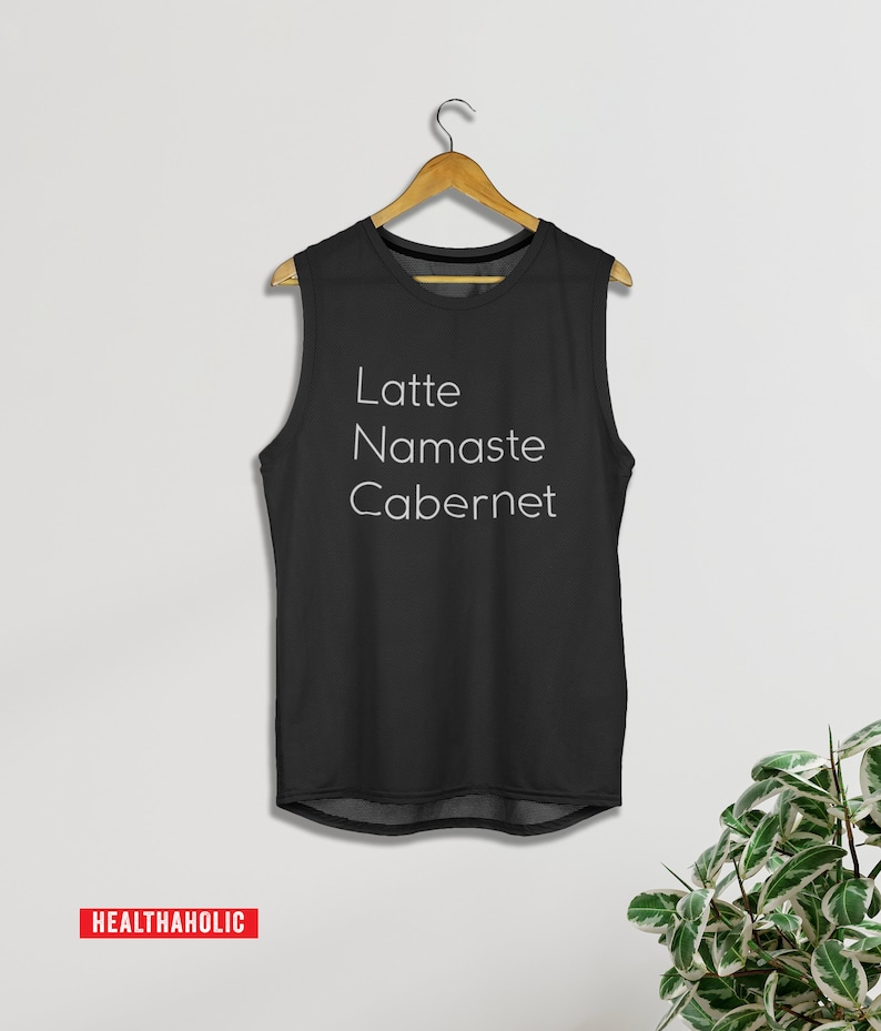 May include: Black sleeveless tank top with the text "Latte Namaste Cabernet" in white.