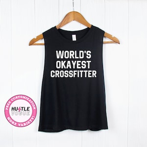 May include: Black sleeveless tank top with the text "WORLD'S OKAYEST CROSSFITTER" in white.