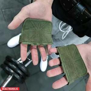 May include: A pair of green fingerless weightlifting gloves with a Union Jack design. The gloves are made of suede and have a strap that goes around the wrist.