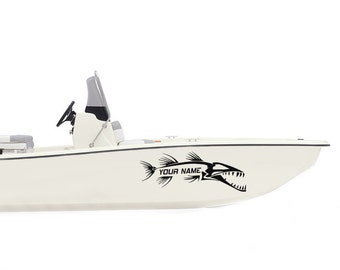 May include: A white boat with a black fish decal on the side. The decal has the text "YOUR NAME" on it.