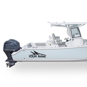 May include: A white boat with a black decal that says "YOUR NAME" on the side. The boat has a hardtop and a single outboard motor.