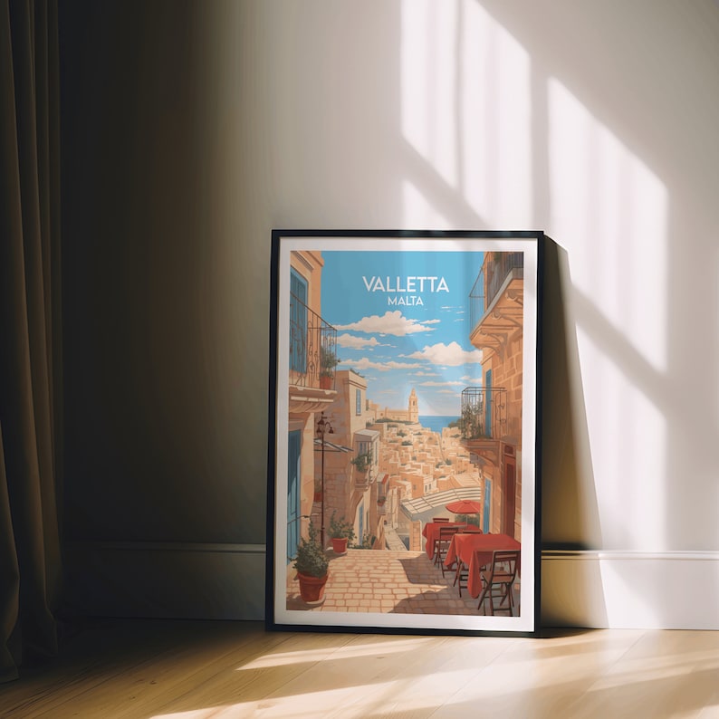 May include: A vintage-style travel poster featuring a colorful illustration of a narrow street in Valletta, Malta. The poster has a blue sky with white clouds and a view of the Mediterranean Sea in the background. The text "Valletta Malta" is printed in white at the top of the poster.