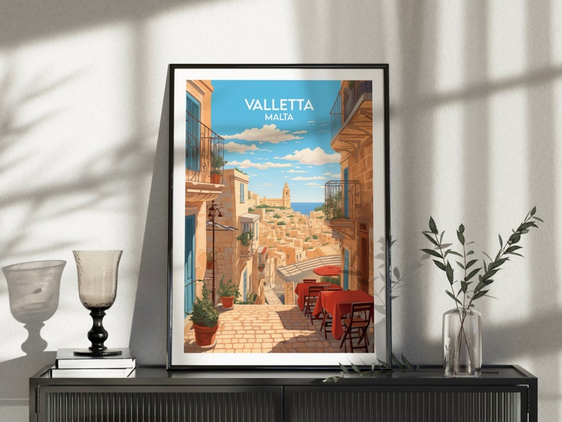 May include: A colorful illustration of a street scene in Valletta, Malta. The image shows a narrow street with buildings on both sides, a blue sky with white clouds, and a view of the sea in the distance. The text "Valletta Malta" is printed at the top of the image.