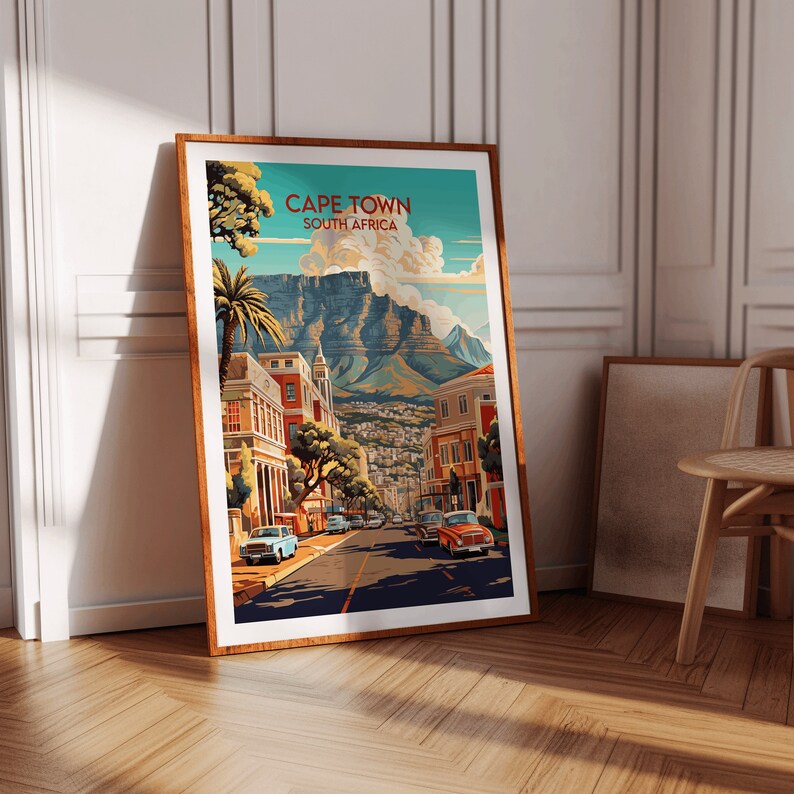 May include: A vintage travel poster featuring a colorful illustration of Cape Town, South Africa. The poster depicts a street scene with buildings, palm trees, and cars, with Table Mountain in the background. The text "CAPE TOWN" and "SOUTH AFRICA" is displayed in a retro font.
