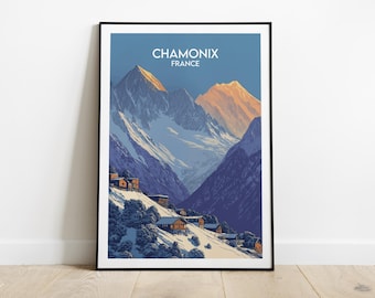 May include: A framed art print of a mountain scene in Chamonix, France. The image shows snow-covered mountains and a village at the foot of the mountains. The sky is blue, and the mountain peaks are lit with a golden hue.