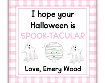 May include: A square card with a pink and white gingham border. The card features the text "I hope your Halloween is SPOOK-TACULAR" with illustrations of ghosts and a mummy. The card is signed "Love, Emery Wood."