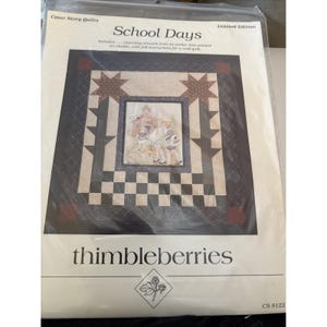 May include: A "School Days" quilt kit by Thimbleberries. The kit includes a quilt pattern with charming artwork, full instructions, and a limited edition design. The quilt features a central image of children and a schoolhouse, surrounded by a checkerboard pattern.