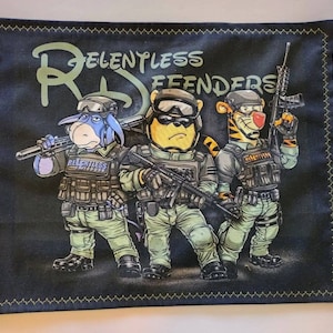 May include: Black square pillow with a cartoon image of Winnie the Pooh characters dressed in military gear, holding weapons. The text "RELENTLESS DEFENDERS" is above the characters. The pillow has a yellow stitched border.