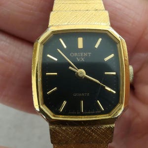 Vintage gold tone ORIENT quartz watch black dial