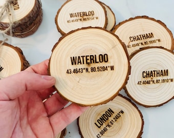 May include: Wooden coasters with the names of different cities and their coordinates engraved on them. The cities include London, Toronto, Waterloo, and Chatham.